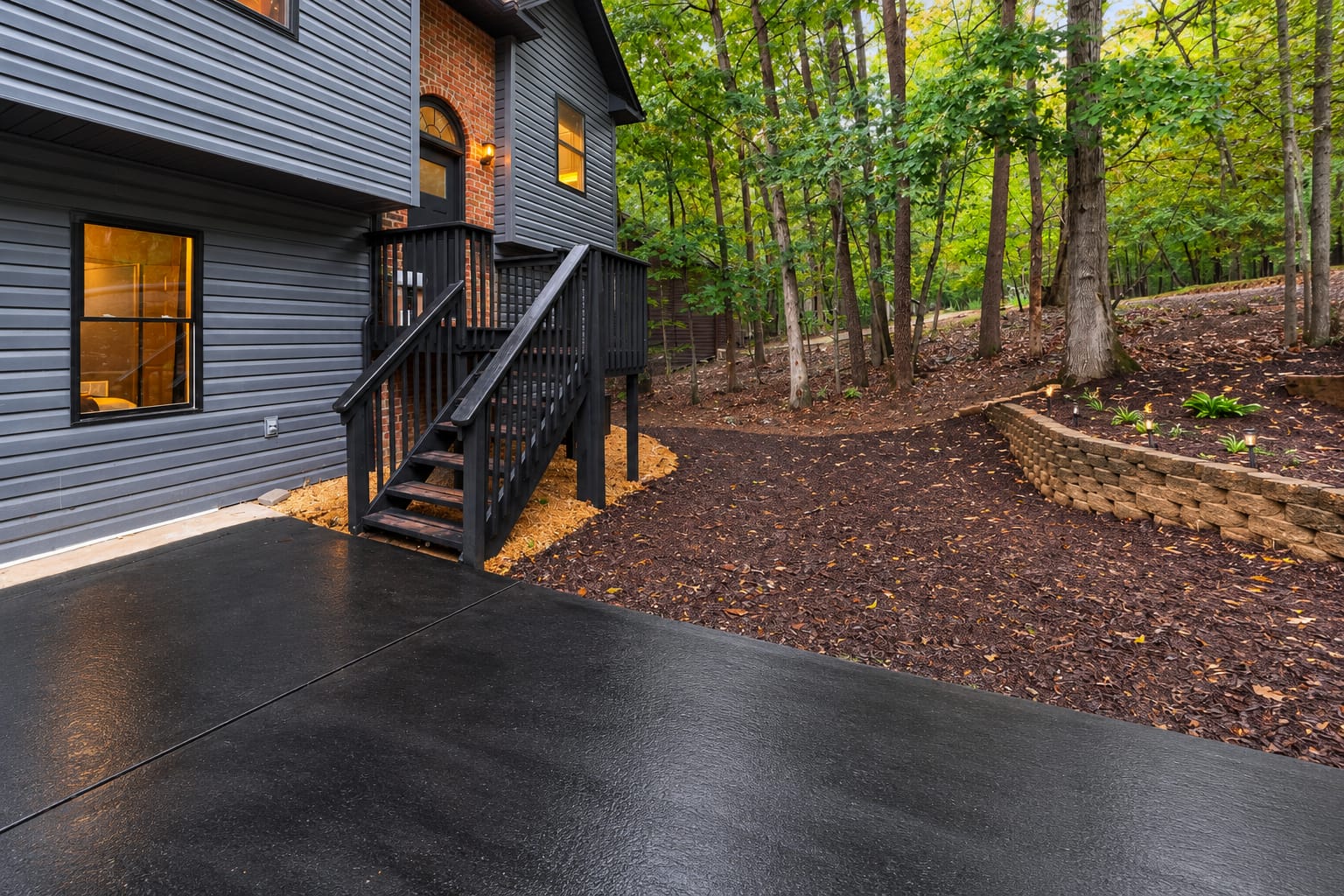Side exterior with stairs and landscaped retaining wall